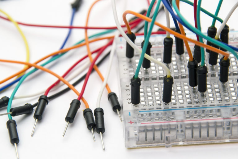 Breadboard and Jumper Cable Wires close up on white background